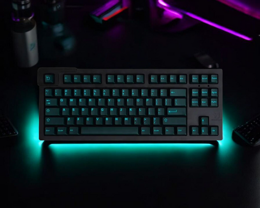 Cyan translucent keycap set illuminating a mechanical keyboard with vibrant glow.