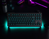 Cyan translucent keycap set illuminating a mechanical keyboard with vibrant glow.