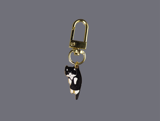 Hang in there black and white cat keychain with durable lobster clasp, gold plated alloy, and stainless steel.