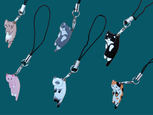 Phone lanyard straps with cute cat designs made of gold and silver plated enamel, alloy, stainless steel, and waterproof fabric.