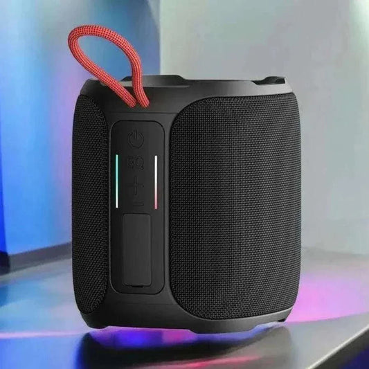 Waterproof Bluetooth speaker with RGB lights, black design, red loop, and control buttons, showcased on a colorful backdrop.