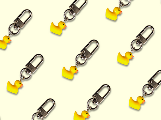 Mini duck keychain with lobster clasp and stainless steel accents.